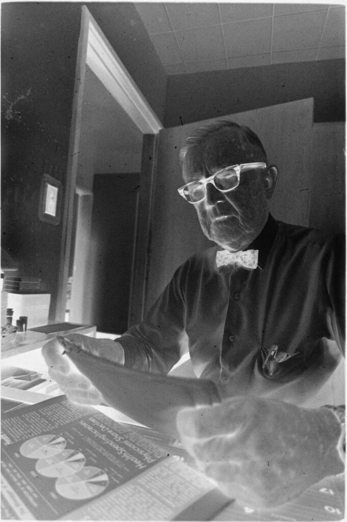 Untitled (Dr. Herman M. Juergens At Desk In Office Looking At Papers)