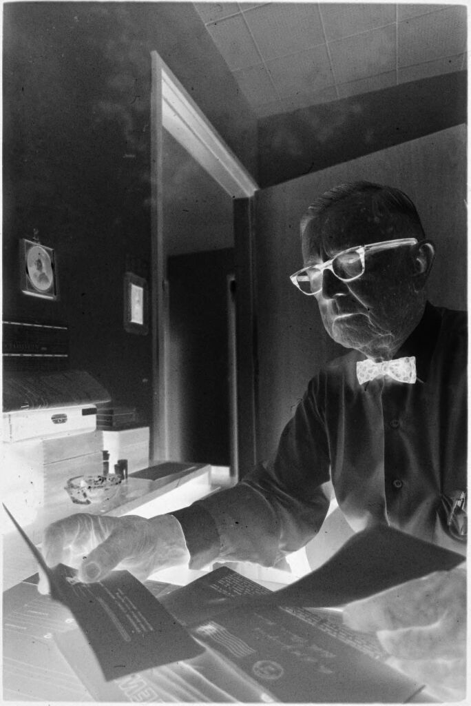 Untitled (Dr. Herman M. Juergens At Desk In Office Looking At Papers)
