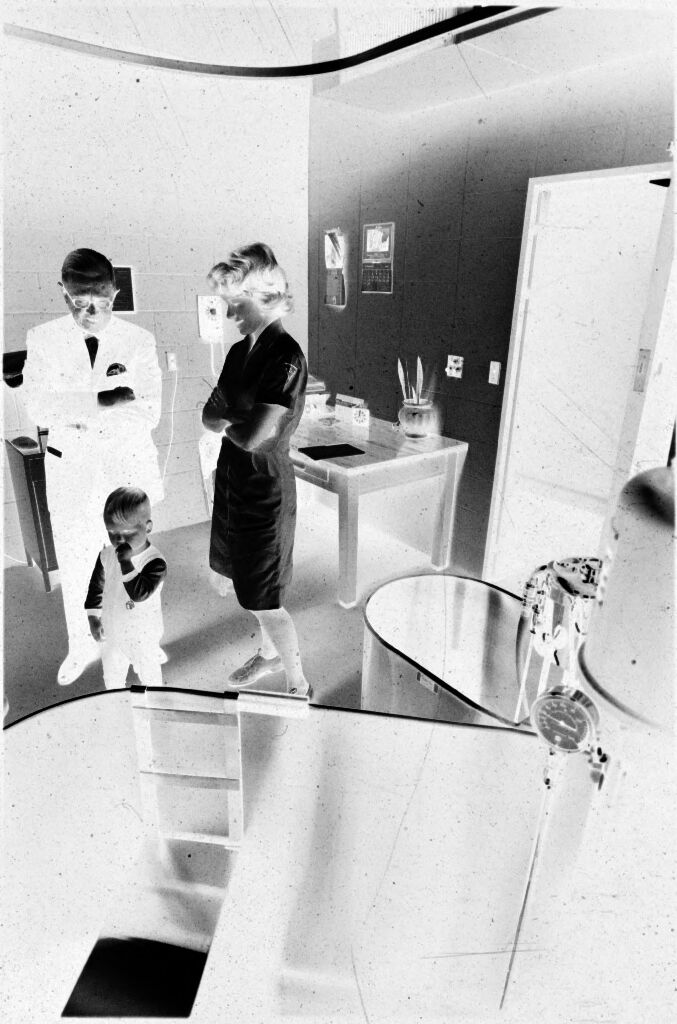 Untitled (Dr. Herman M. Juergens And Nurse With Toddler In Treatment Room)