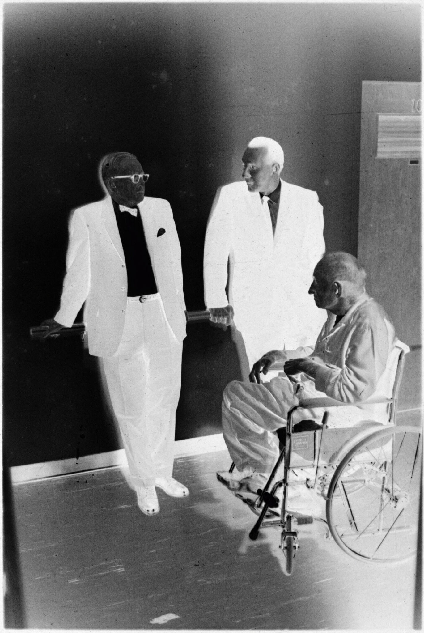 Untitled (Two Doctors With Patient In Wheelchair In Hallway)