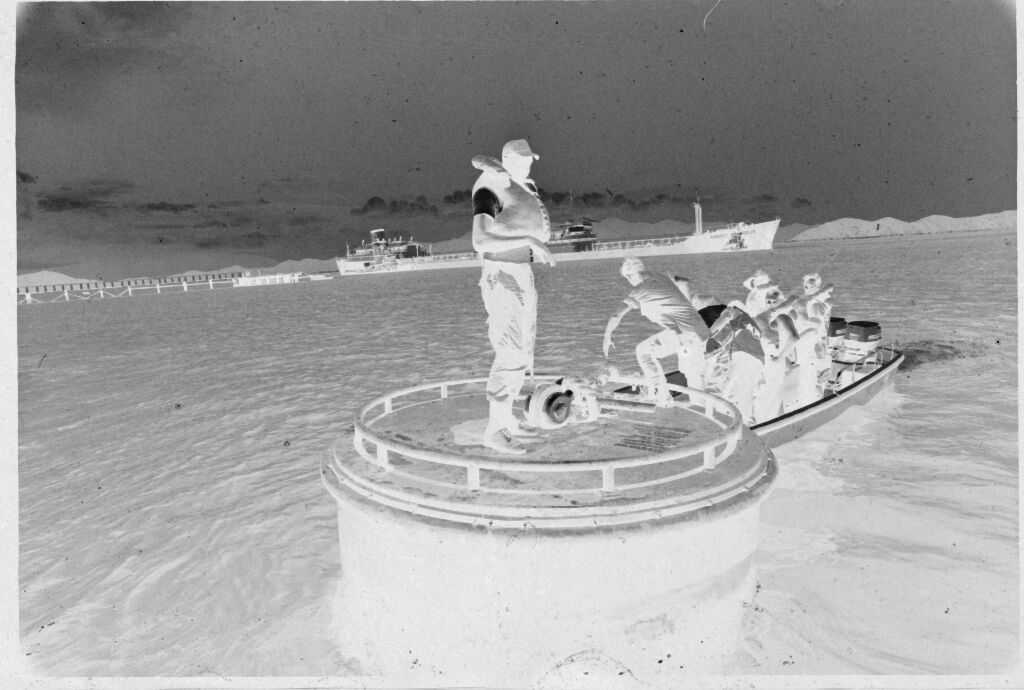 Untitled (Men Stepping From Top Of Submarine(?) To Motorboat, Vietnam?)
