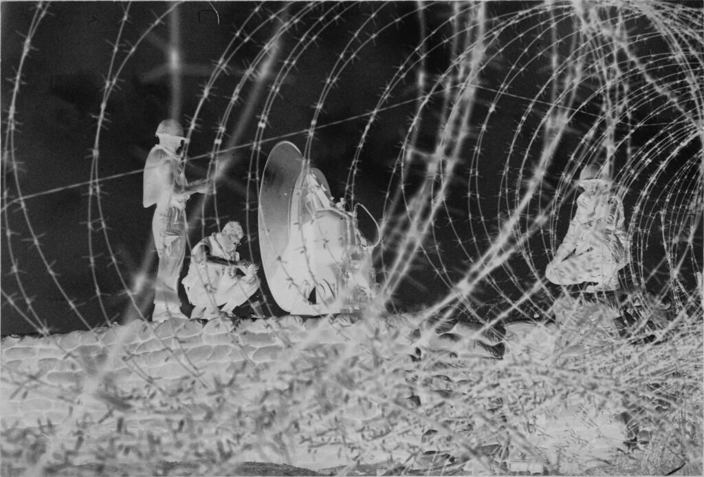 Untitled (Soldiers With Satellite Dish(?) Behind Barbed Wire, Vietnam)