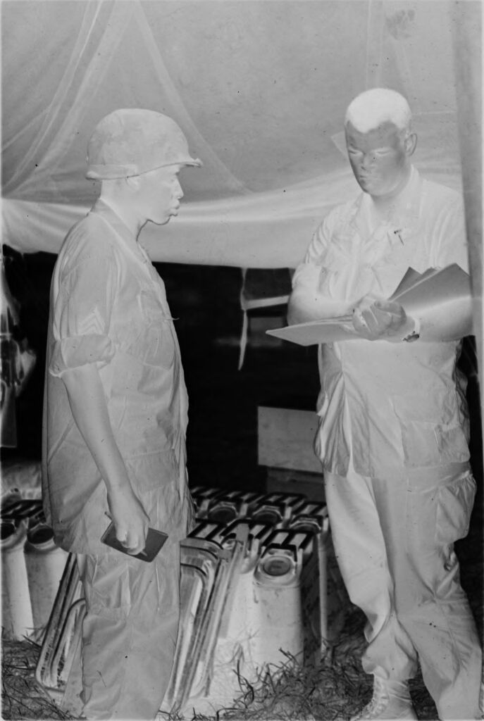 Untitled (Two Soldiers Talking Under Large Tent, Vietnam)