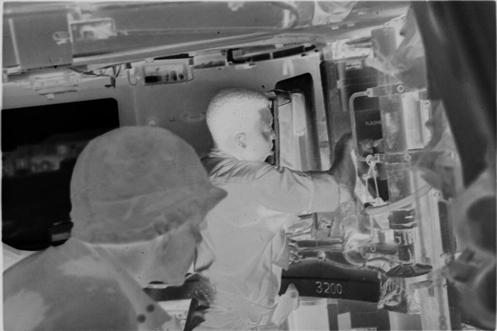 Untitled (Soldiers Checking Controls Or Supplies Inside Aircraft, Vietnam)