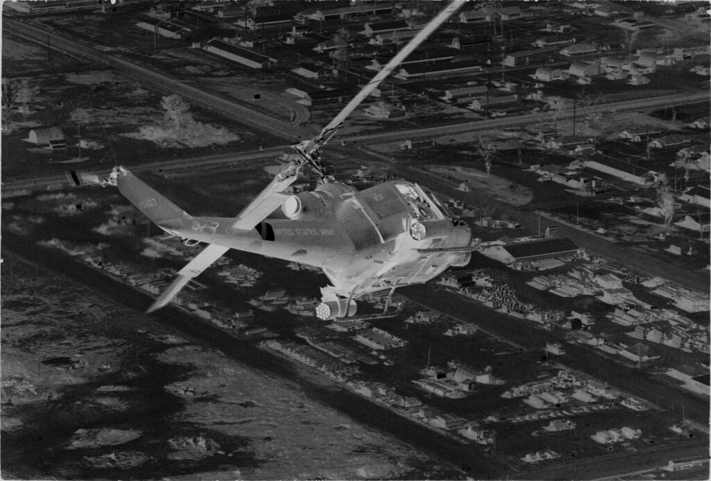 Untitled (Aerial View Of Helicopter Flying Over Army Base, Vietnam)