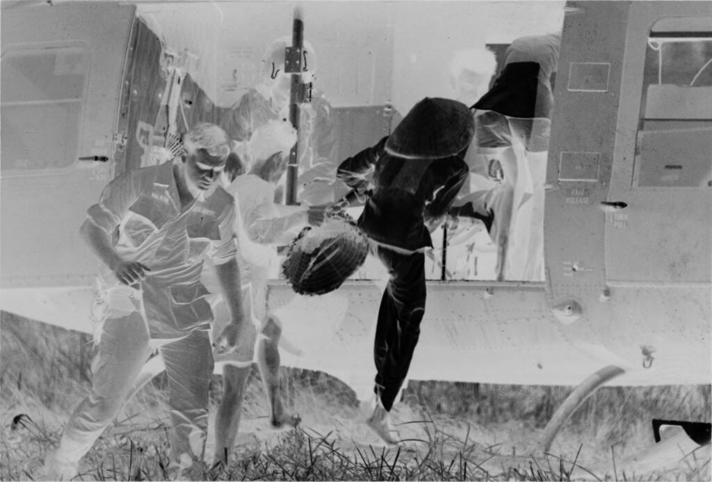 Untitled (Soldiers And Vietnamese In Field Boarding Helicopter, Vietnam)