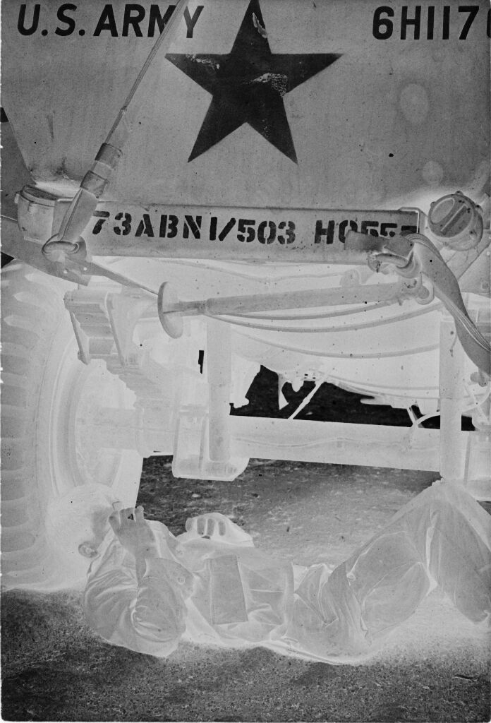 Untitled (Soldier Lying On Ground Under Army Vehicle Covering Face With Jacket, Vietnam)