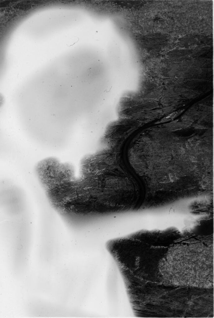 Untitled (Aerial View Of River Valley From Helicopter With Profile Silhouette Of Soldier In Foreground, Vietnam)