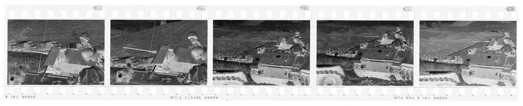 Untitled (Soldier On Top Of Army Tank With Cargo Trunks Lined Up Along Road In Background, Vietnam)