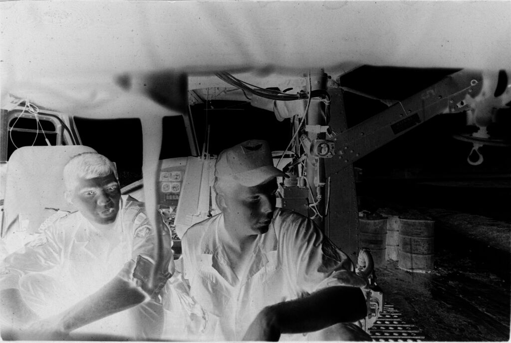 Untitled (Medevac Team Seated Inside Grounded Helicopter, Vietnam)
