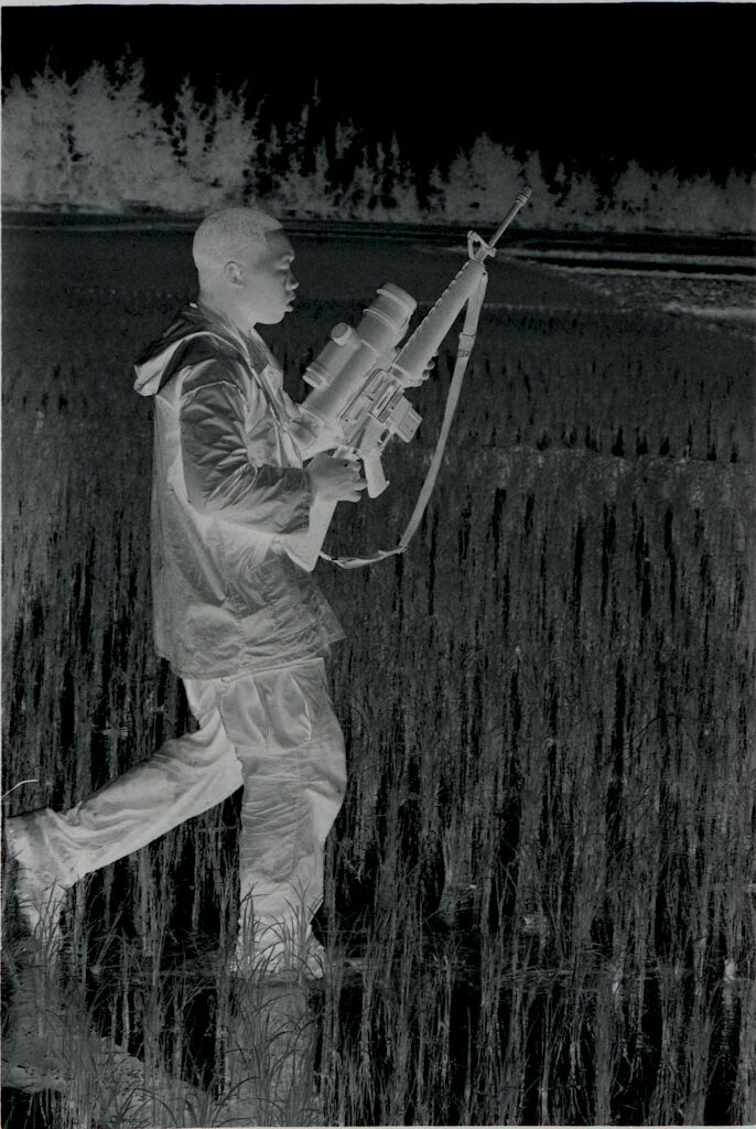 Untitled (Soldier Walking Through Rice Paddy Carrying Rifle With Sight Attachment, Vietnam)