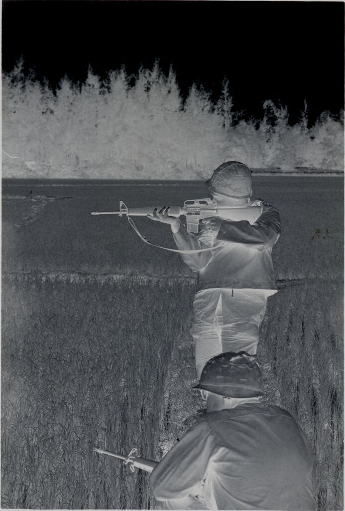 Untitled (Two Soldiers With Rifles In Rice Paddy, One Standing And Aiming, One Crouched, Vietnam