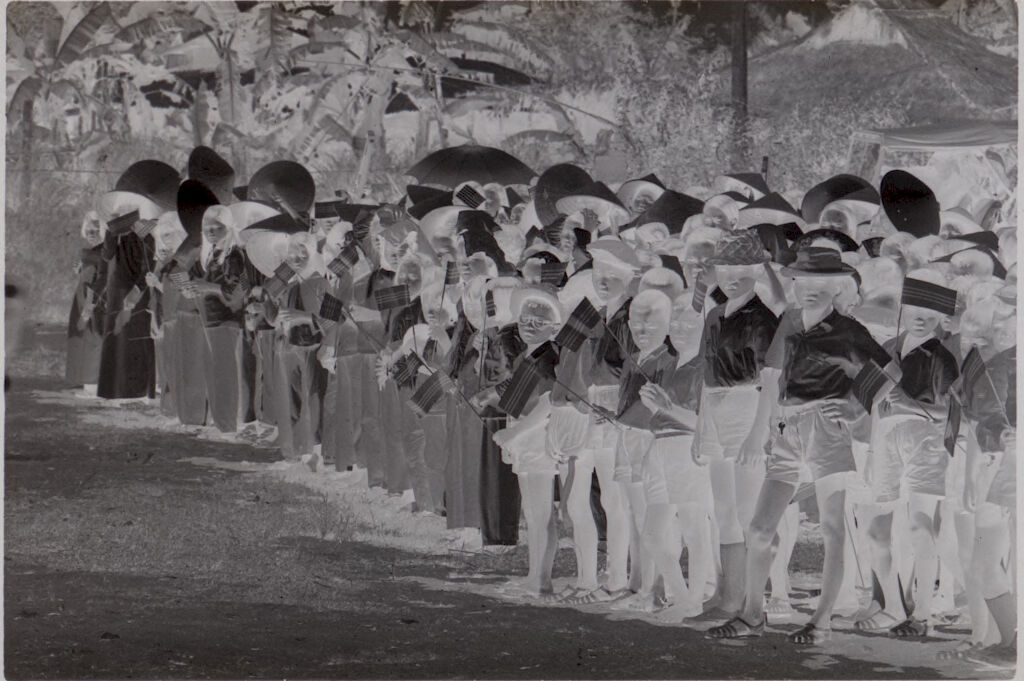 Untitled (Parade Route With People Lined Up Along Side Of Street Holding Flags, Vietnam)