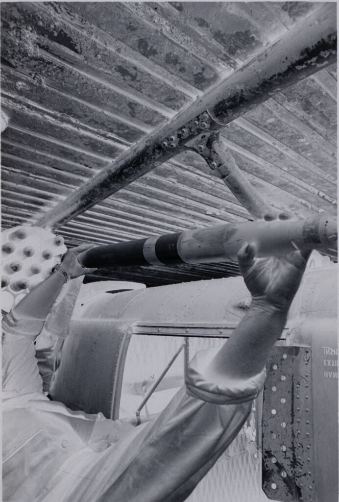 Untitled (Soldier Loading Ammunition Into Cylinder Below Helicopter, Vietnam)