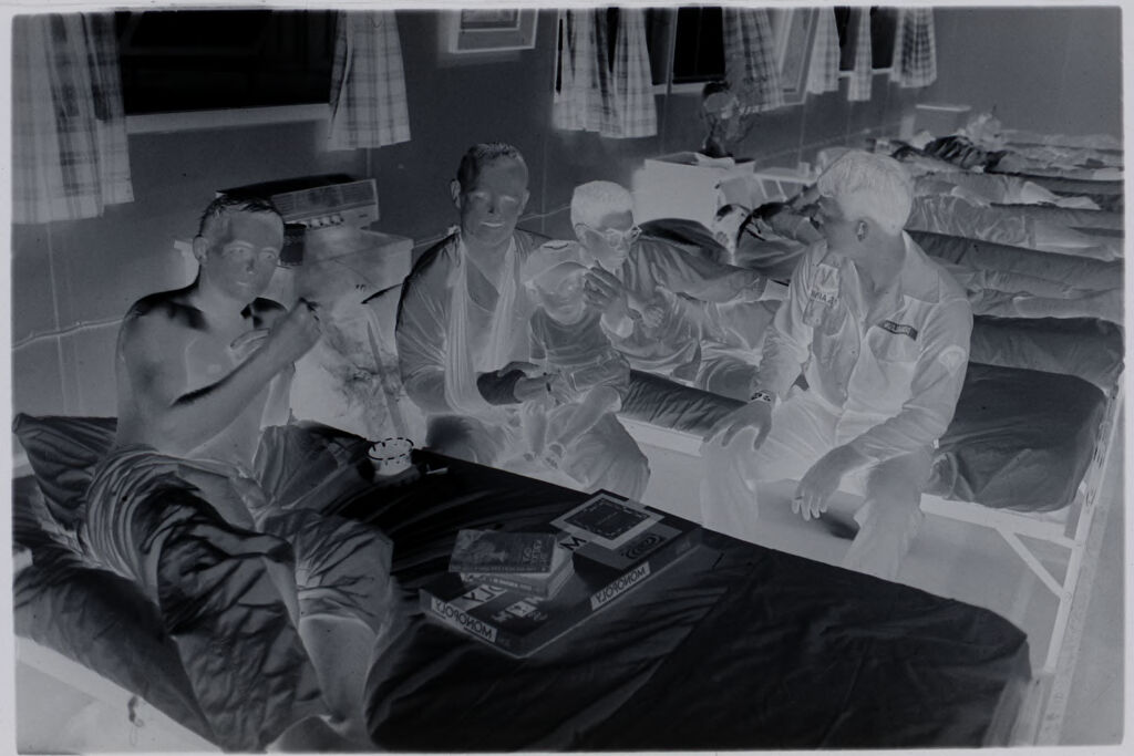 Untitled (Recovering Soldiers In Hospital Ward Playing With Vietnamese Child, Vietnam)