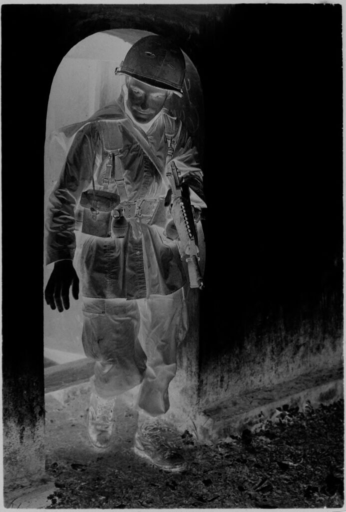 Untitled (Soldier In Combat Attire Coming Out Of Doorway, Vietnam)