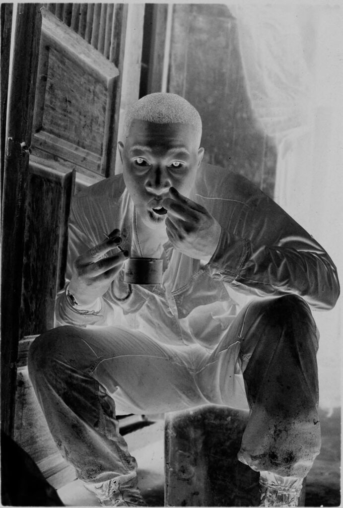 Untitled (Soldier Seated In Doorway Eating From A Can, Vietnam)