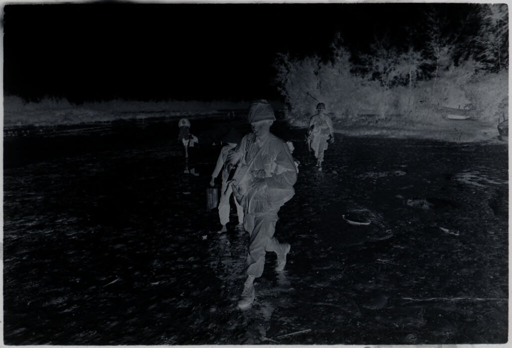 Untitled (Soldiers Carrying Gear Across Field, Vietnam)