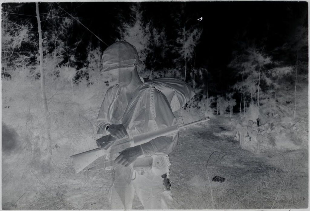 Untitled (Soldier With Combat Gear Walking Through Field, Vietnam)