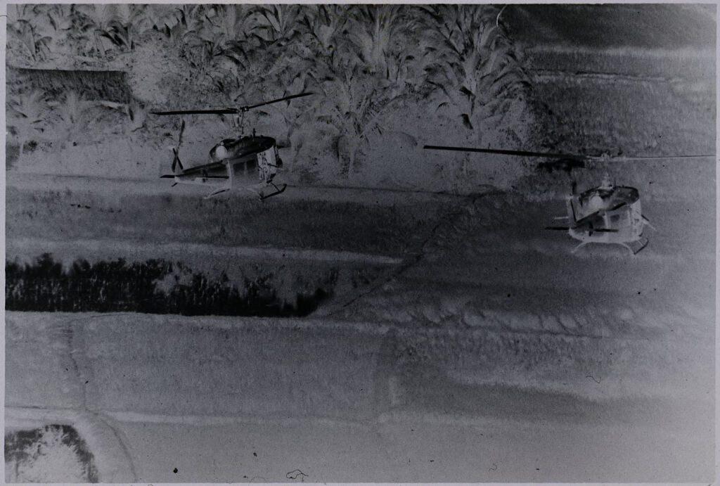 Untitled (Aerial View Of Two Helicopters Flying Over Field, Vietnam)
