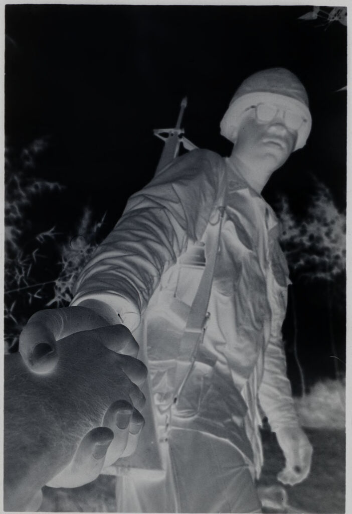 Untitled (Worm's-Eye View Of Soldier Standing In Rice Field Helping Someone Up, Vietnam)