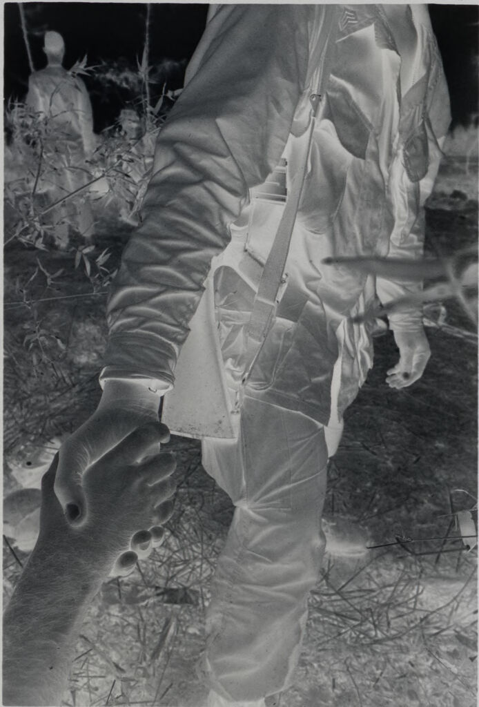 Untitled (Worm's-Eye View Of Soldier Standing In Rice Field Helping Someone Up, Vietnam)