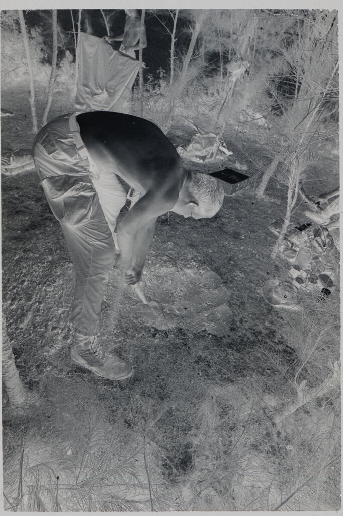 Untitled (Soldier Digging Hole In Small Clearing, Vietnam)