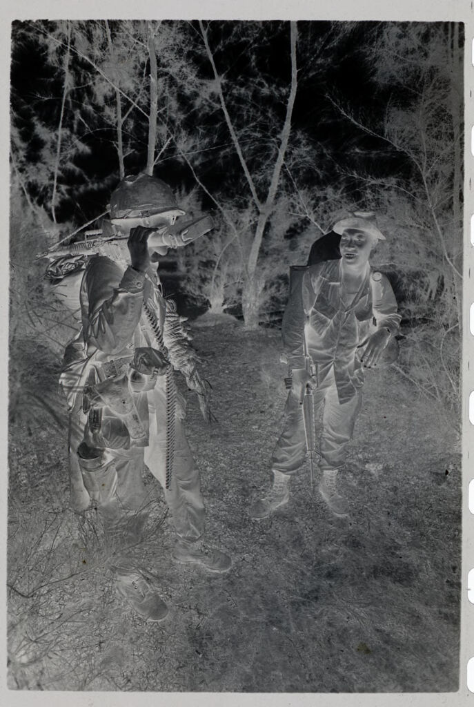 Untitled (Two Soldiers Stopped On Trail To Talk, Vietnam)