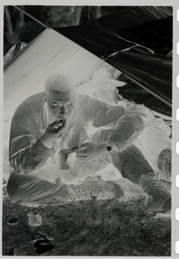 Untitled (Soldier Eating Canned Food Under A Make-Shift Tent, Vietnam)
