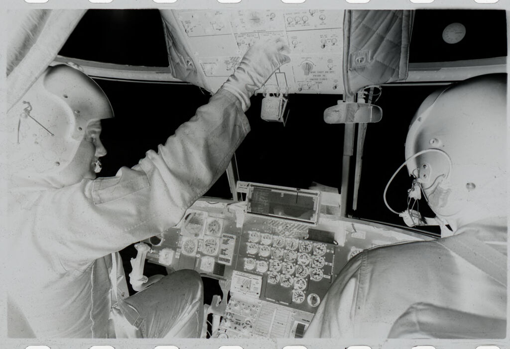 Untitled (Soldiers In Helicopter Cockpit Adjusting Overhead Controls, Vietnam)