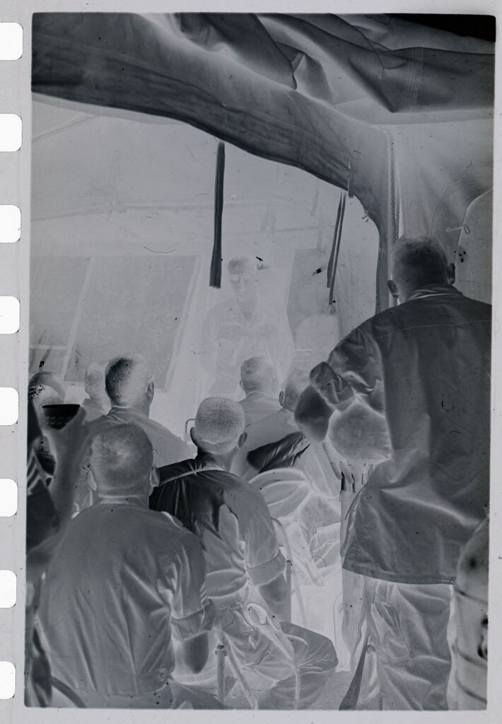 Untitled (View Inside Makeshift Classroom With Soldiers Sitting In Front Of Chalkboard, Vietnam)