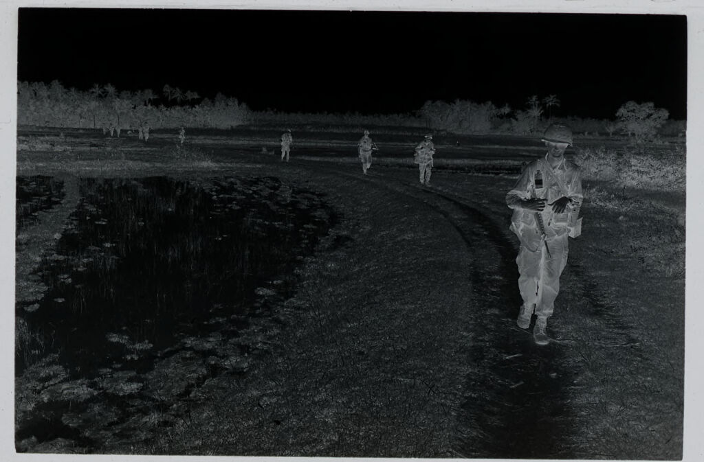Untitled (Soldiers Walking Along Dirt Path In Rice Paddy, Vietnam)