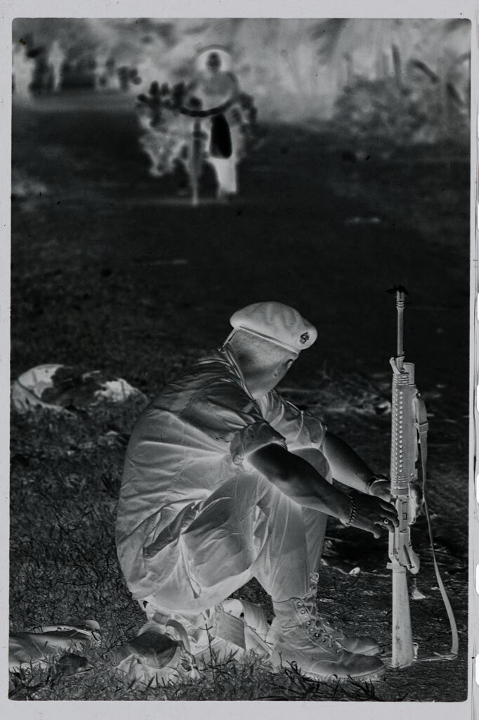 Untitled (Soldier With Rifle Seated By Side Of Road, Vietnam)