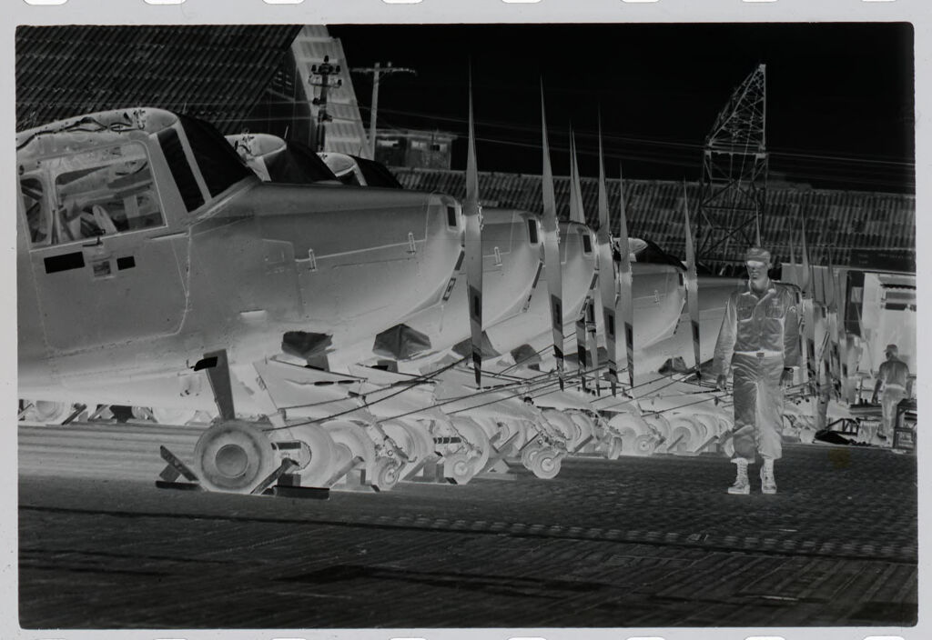 Untitled (Soldier Walking By Row Of Grounded Helicopters, Vietnam)