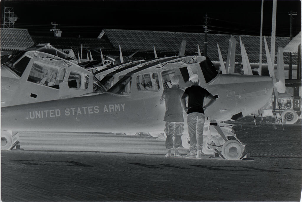 Untitled (Soldiers Inspecting Propeller Plane Grounded At Base, Vietnam)