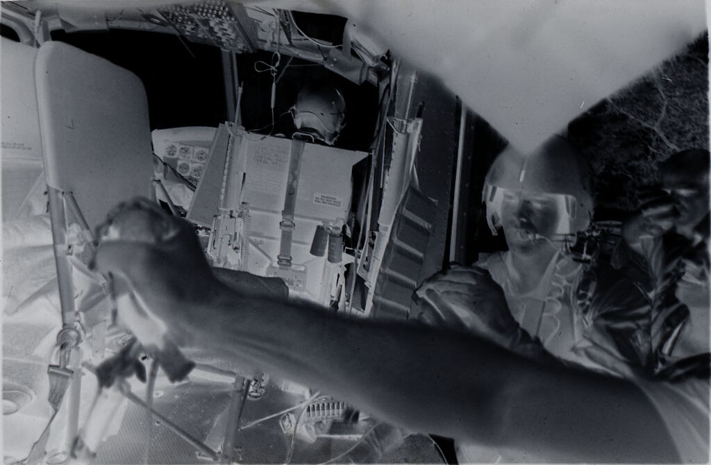 Untitled (Member Of 57Th Medical Detachment And Army Medics Holding Plasma Containers For Wounded Soldier Inside Medevac Helicopter, Vietnam)