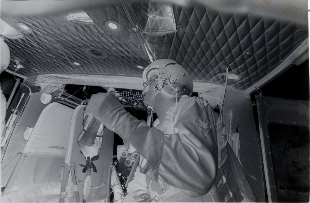 Untitled (Member Of 57Th Medical Detachment Holding Plasma Container For Wounded Soldier Inside Medevac Helicopter, Vietnam)