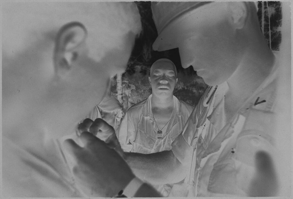 Untitled (Soldiers Pinning Insignia On Uniforms, Vietnam)